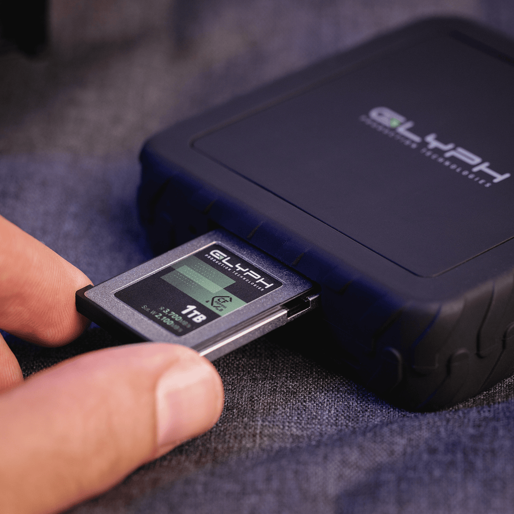 Person inserting Glyph memory card into card reader