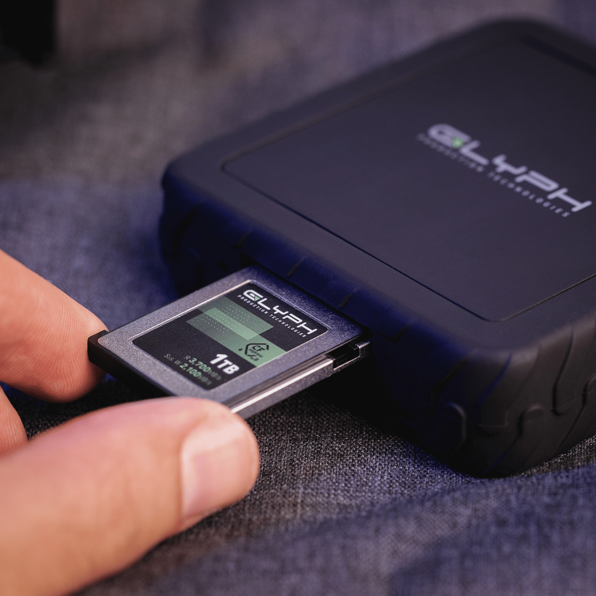Person inserting Glyph memory card into card reader